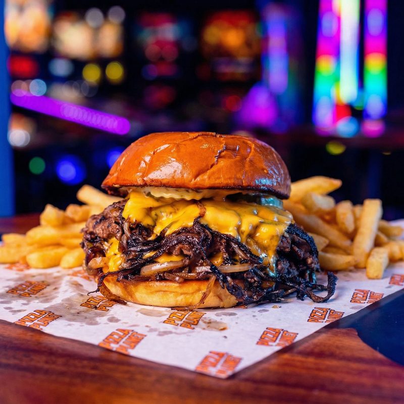 The Number 9 Large - beef patty with American cheese melting over the edge, on a brioche bun, with shoestring fries on the side.