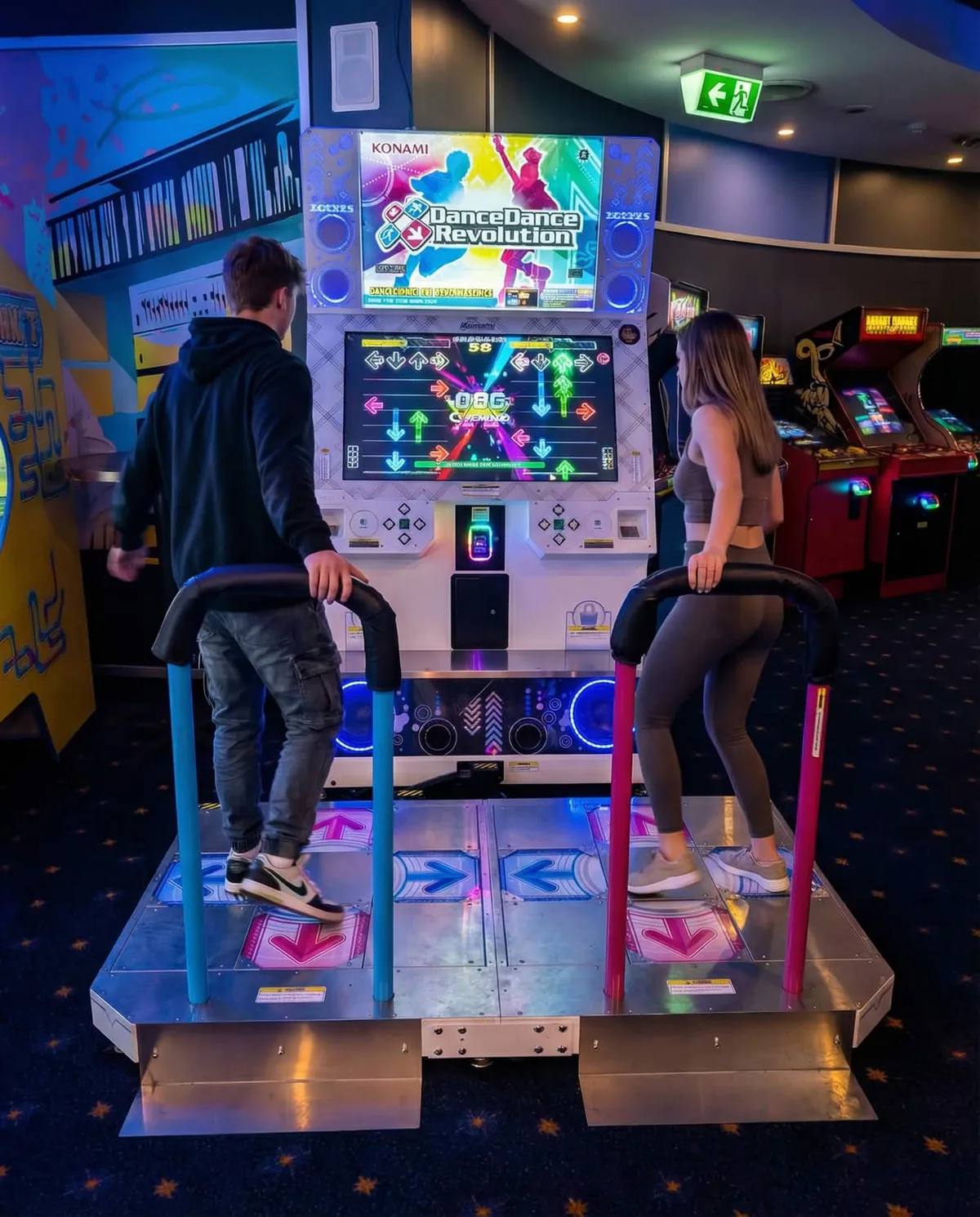 Two guests playing Dance Dance Revolution at a Planet Royale function