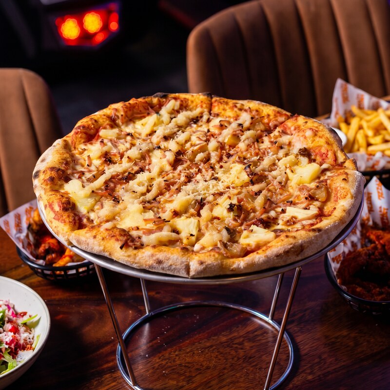 Cluckin' Bell BBQ Chicken pizza - grilled chicken with BBQ sauce, mozzarella and cheddar.