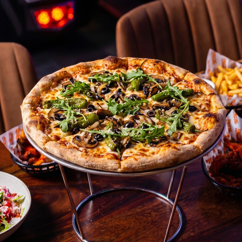 Green Sabre Veggie pizza - rocket, green peppers, mushrooms, black olives and onions on melted mozzarella.